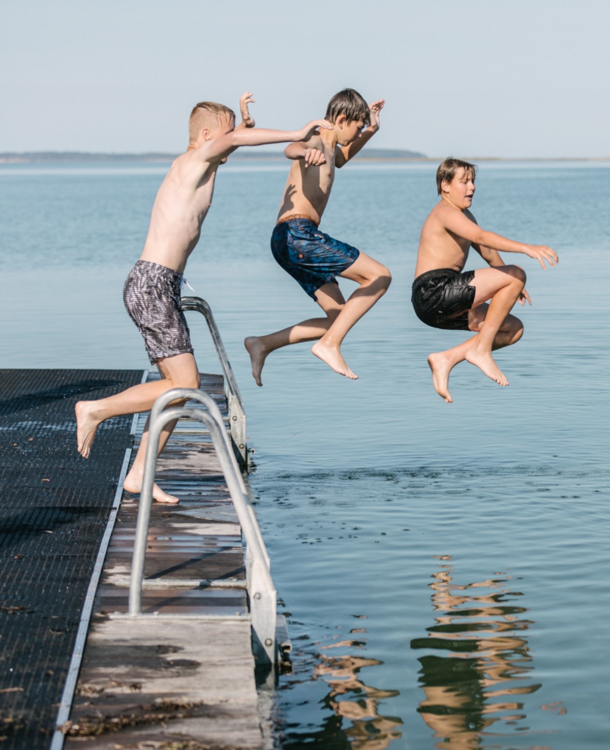 Drenge springer i vandet fra flydebroer i Bogense
